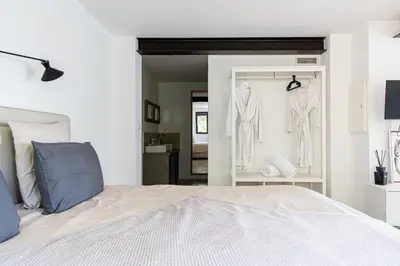 a bedroom with a bed and two racks of robe at Mas lou Félibrige in Venelles