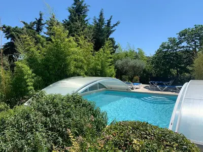 a swimming pool in a yard with trees and bushes at Bastide Sainte Agnès in Carpentras