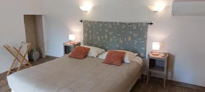 a bedroom with a bed with two pillows on it at Bastide Sainte Agnès in Carpentras