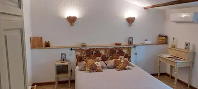 a bedroom with a bed with pillows on it at Bastide Sainte Agnès in Carpentras