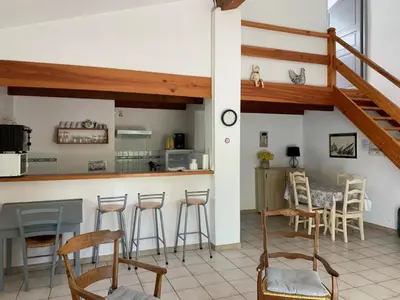 a kitchen with a counter and stools in a room at Gîte les Cyprès (Bastide Sainte Agnès) in Carpentras