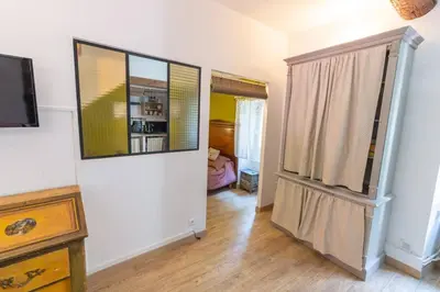 a room with a hallway with a door and a television at Havre de paix en Provence in Lauris