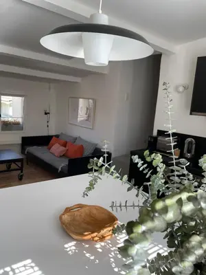 a living room with a couch and a table at La Magnanerie in LʼIsle-sur-la-Sorgue