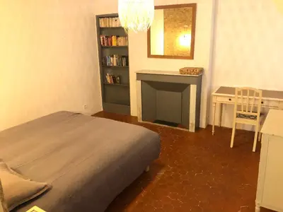 a bedroom with a bed and a fireplace and a desk at Beau 3 pièces 83 m2 au coeur du centre historique d'Aix en Provence in Aix-en-Provence