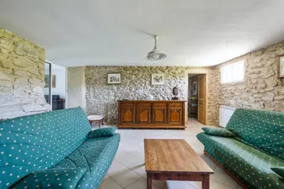 a living room with two blue couches and a wooden table at Villa charmante à La Tour-d'Aigues avec piscine privée in La Tour-dʼAigues