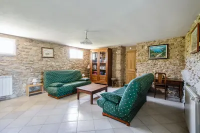 a living room with two chairs and a table at Villa charmante à La Tour-d'Aigues avec piscine privée in La Tour-dʼAigues