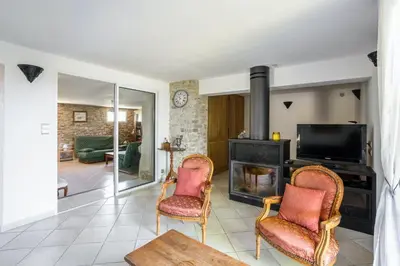 a living room with two chairs and a fireplace at Villa charmante à La Tour-d'Aigues avec piscine privée in La Tour-dʼAigues