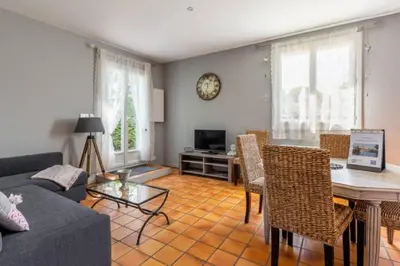 a living room with a couch and a table at La Bastide de l Etang in LʼIsle-sur-la-Sorgue