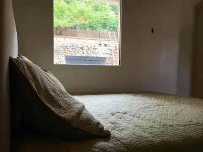a bed in a room with a window at l'Ecurie in Bonnieux