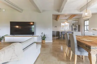 a kitchen and dining room with a large television and a table at Mas Carla in Noves