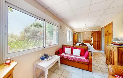 a living room with a couch and a large window at 2 Bedroom Gorgeous Apartment In Caromb in Caromb