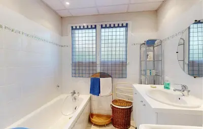 a white bathroom with a tub and a sink at 2 Bedroom Gorgeous Apartment In Caromb in Caromb
