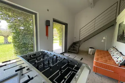 a stove in a living room with a large window at Mas de Panière - Saint Remy de Provence in Paluds de Noves