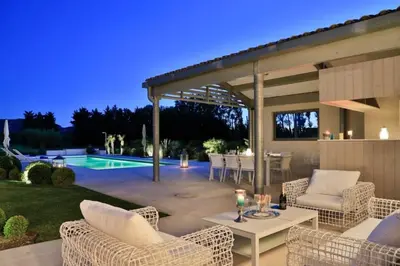 a patio with chairs and a table and a pool at Mas de Panière - Saint Remy de Provence in Paluds de Noves