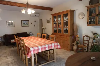 a living room with a table and a couch at CLOS DE LA FONT in Mollégès
