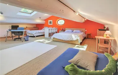 a bedroom with two beds and an orange wall at 4 Bedroom Stunning Home In Lagnes in Lagnes