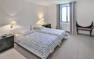 a bedroom with two beds and a window at 4 Bedroom Stunning Home In Lagnes in Lagnes