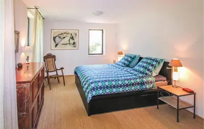 a bedroom with a bed and a couch and a table at 4 Bedroom Stunning Home In Lagnes in Lagnes