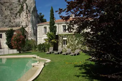 a house with a swimming pool and chairs in the yard at Auberge Du Parc in Orgon