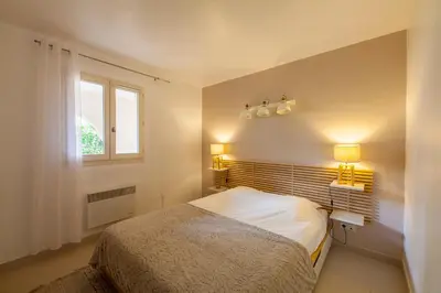 a small bedroom with a bed and a window at Le Cigalou in Mallemort