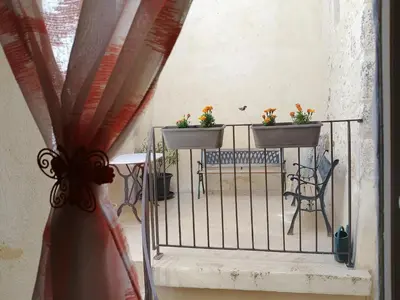 a balcony with two plants on a fence at Gîte Pilpoil in Sault-de-Vaucluse