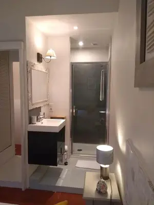 a bathroom with a sink and a shower with a mirror at Mas de Camejean in Lambesc