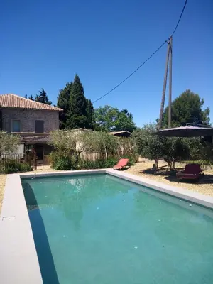 a swimming pool in front of a house at Mas de Camejean in Lambesc