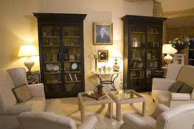 a living room with couches and chairs and a table at Hostellerie Le Roy Soleil in Ménerbes