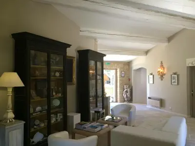 a living room with a couch and some chairs at Hostellerie Le Roy Soleil in Ménerbes