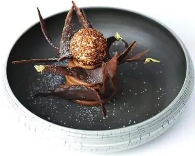 a plate of food with a spider on it at Hostellerie Le Roy Soleil in Ménerbes