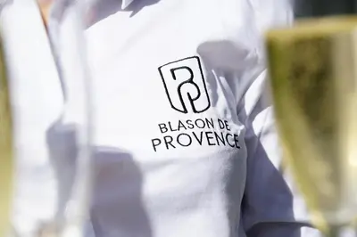 a person wearing a white shirt with the phrase blason be powerless at Logis Hotel Le Blason de Provence in Monteux