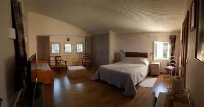 a bedroom with a bed in the middle of a room at Mas du Kairos in Venasque