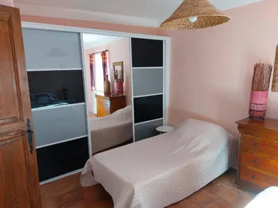 a bedroom with a bed and a large mirror at Gîte de caractère au pied du Mont Ventoux avec piscine couverte in Sault-de-Vaucluse
