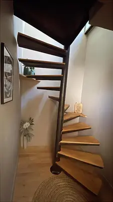 a wooden staircase in a room with a stair case at DUPLEX MIRABEAU - Roof terrace with panoramic view in Aix-en-Provence