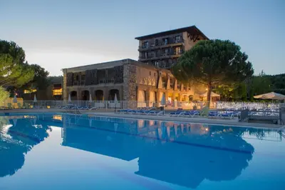 a swimming pool in front of a building at Vacances Bleues Hôtel Castel Luberon in Apt