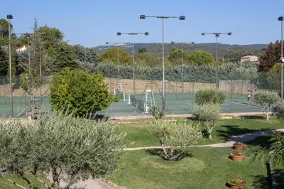 a tennis court with two tennis courts at Vacances Bleues Hôtel Castel Luberon in Apt