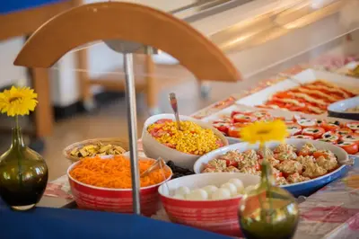 a buffet with different types of food on a table at Vacances Bleues Hôtel Castel Luberon in Apt