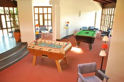 a room with a foosball table and a pool table at Vacances Bleues Hôtel Castel Luberon in Apt