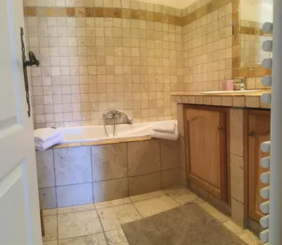 a bathroom with a tub and a sink at Vacation rental in the Alpilles, Provence, close to the village center - Beautiful view -Air conditionning Heated pool and spa - sleeps 8 in Aureille
