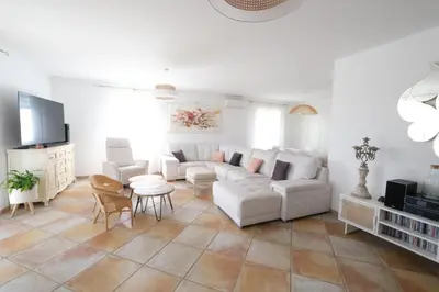 a living room with a couch and a table at Vacation rental in the Alpilles, Provence, close to the village center - Beautiful view -Air conditionning Heated pool and spa - sleeps 8 in Aureille