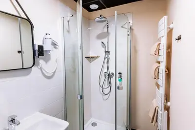 a bathroom with a shower and a sink at Le Nesk Ventoux - Hotel in Sault-de-Vaucluse