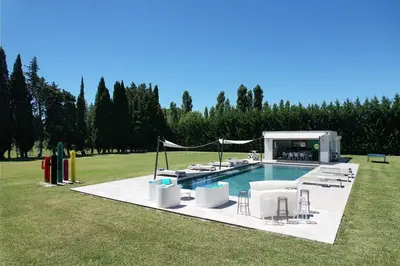 a pool with a group of chairs around it at provencal farm house with heated pool located to salon de provence, 12 people in Salon-de-Provence