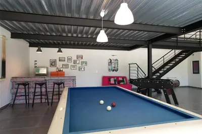 a garage with a pool table and a bar at provencal farm house with heated pool located to salon de provence, 12 people in Salon-de-Provence