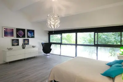 a bedroom with a large bed and a chandelier at provencal farm house with heated pool located to salon de provence, 12 people in Salon-de-Provence