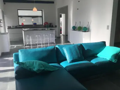a blue couch with pillows in a living room at provencal farm house with heated pool located to salon de provence, 12 people in Salon-de-Provence