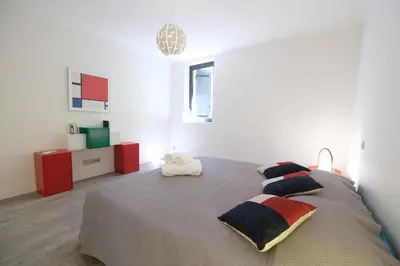 a bedroom with a large bed with two pillows at provencal farm house with heated pool located to salon de provence, 12 people in Salon-de-Provence