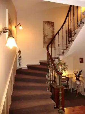a staircase in a home with a stair case at Hôtel du Parc, Avignon Est, The Originals City, in Entraigues-sur-la-Sorgue