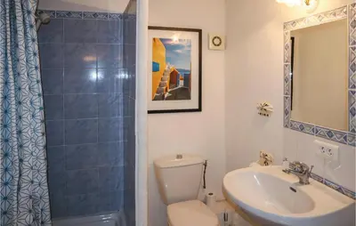 a bathroom with a toilet and a sink and a mirror at Cozy Apartment In Villes Sur Auzon in Villes-sur-Auzon