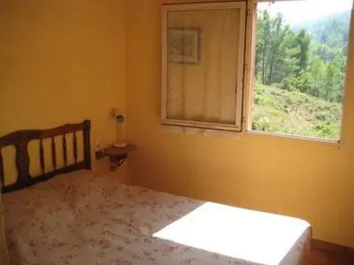 a bedroom with a bed and a window at Gite des Ocres in Villars