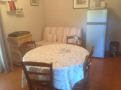 a kitchen with a table and a refrigerator at Gite des Ocres in Villars